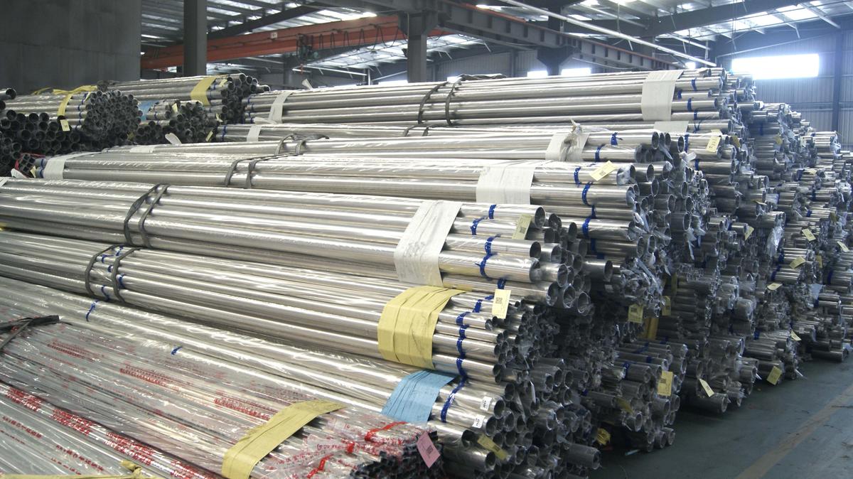 Person standing in a factory with machinery in the background